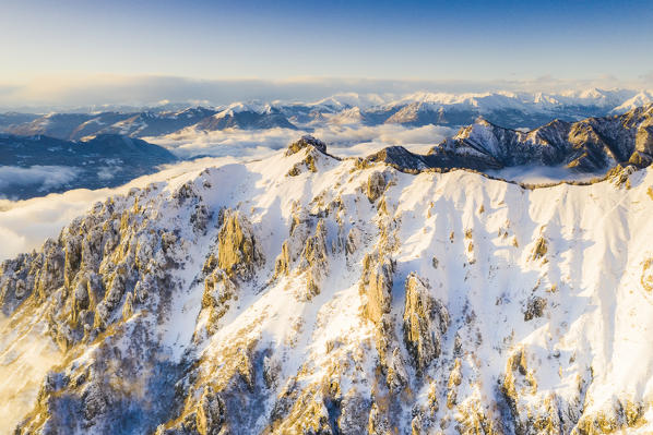 Aerial view of snow capped Torrione del Pertusio and Monti Lariani, Lake Como, Lecco province, Lombardy, Italy