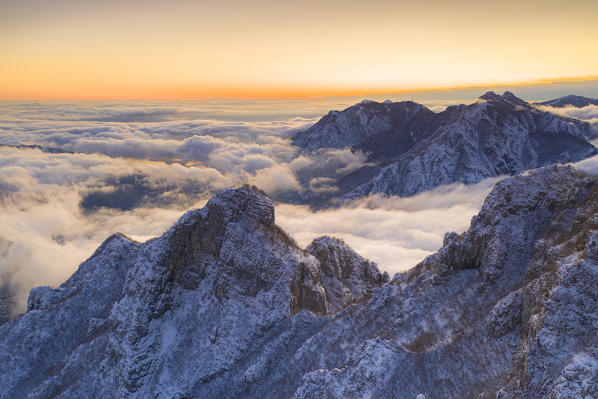 Aerial view of Monte Barro towards Lecco city under the morning mist, Lake Como, Lecco province, Lombardy, Italy