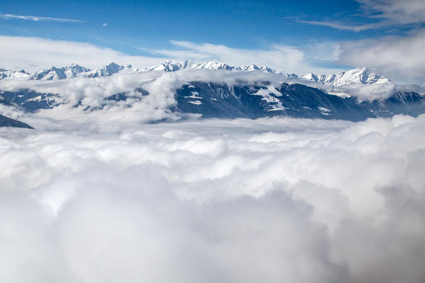 Snowy peaks of Val Gerola emerging from the fog Lower Valtellina, Lombardy Italy Europe
