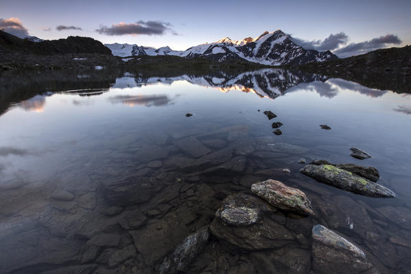 Lake Manzina painted by the early lights at dawn Valfurva, Valtellina, Lombardy Italy Europe