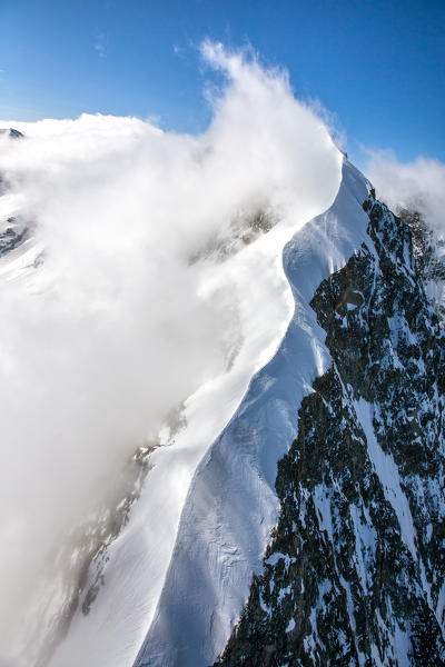 Aerial shot of the Biancograt covered with fog Engadine Switzerland Europe