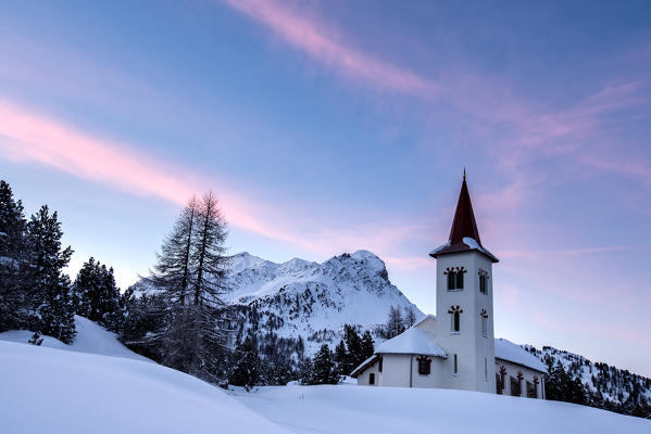 Some painted clouds at dawn by the Church Bianca entitled to Saint Gaudenzio, Maloja, Engadine, Switzerland
