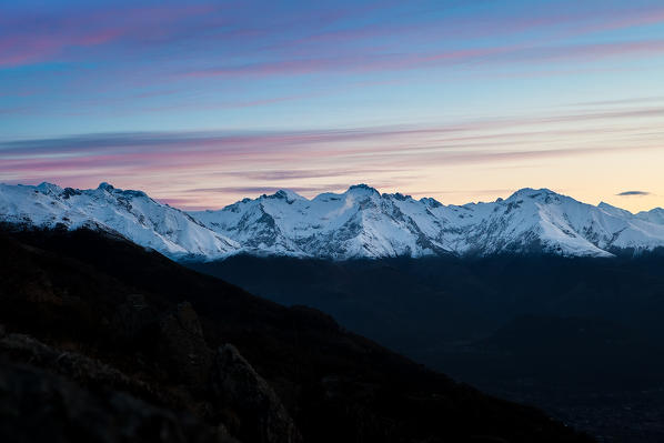 The western Monti Lariani lighted by the first lights of the dawn, High Lario. Lombardy italy Europe