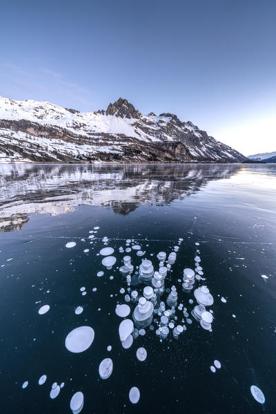 Ice bubbles trapped in the frozen Lake Sils, canton of Graubunden, Engadine, Switzerland