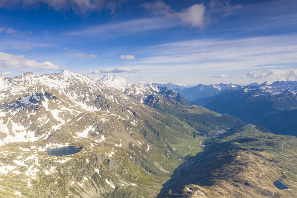 Aerial view of peaks surrounding Lago Nero with Madesimo on background, Valchiavenna, Valle Spluga, Valtellina, Lombardy, Italy
