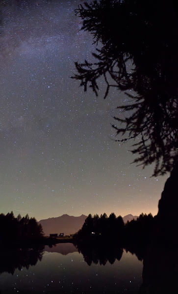 Stars reflection in Lake Azzurro Valchiavenna, Valtellina, Lombardy Italy Europe