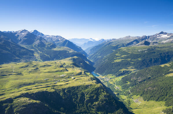 Aerial view of green woods surrounding Chiavenna and Madesimo from Mount Cardine, Valchiavenna, Valtellina, Lombardy, Italy
