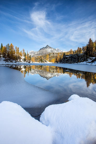Lake of Mufulè is nearly completely frozen after an autumn snowfall, Valmalenco, Valtellina, Lombardy Italy Europe