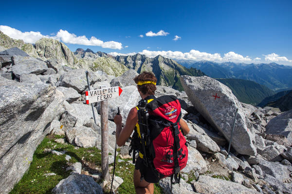 Hiker walking through the Sentiero Roma towards Val del Ferro, Valmasino.Valtellina Lombardy Italy Europe