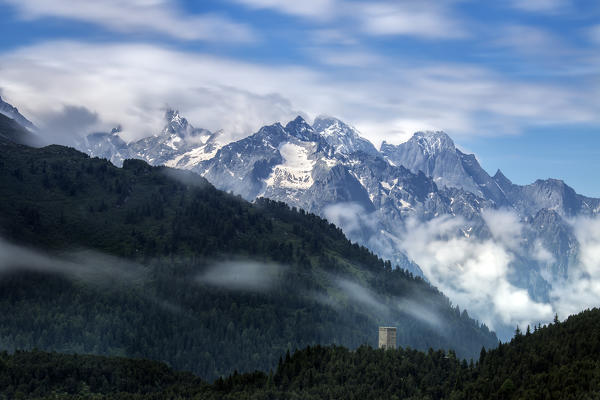 Fog on Tower Belvedere with Pizzo Badile surrounded by clouds. Maloja Pass, Engadine, Canton of Graubunden, Switzerland Europe