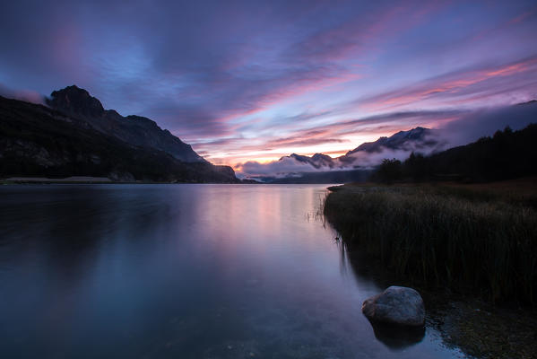 The colours of the dawn reflected in Lake Sils, Maloja Pass.
Enagdine Canton of Graubunden Switzerland Europe