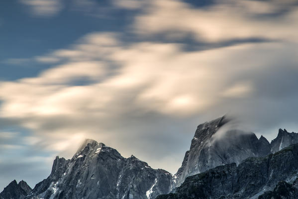 Clouds moved by the wind bumping into the peaks of Pizzo Badile and Pizzo Cengalo at dawn. Soglio Val Bregaglia
Canton of Graubunden Switzerland Europe