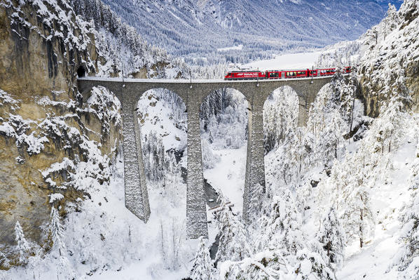 Bernina Express train on Landwasser viaduct in winter, Filisur, canton of Graubunden, Switzerland