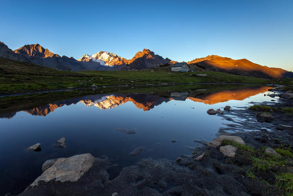 Sunset at Mount Disgrazia seen from a seasonal lake at  Scermendone Alp Raethian Alps, Valtellina, Lombardy, Italy Europe
