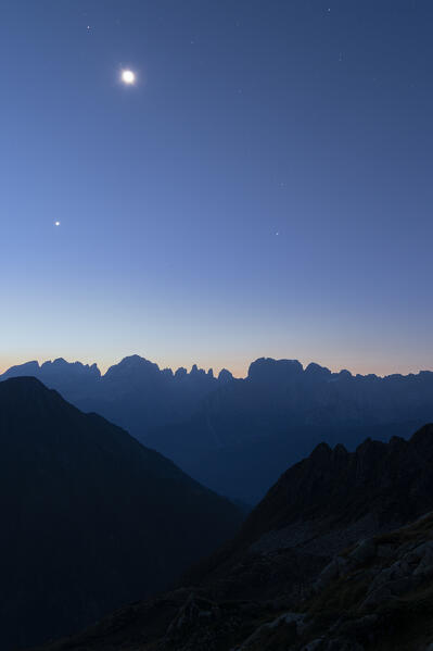 Silhouettes of Brenta Dolomites at dusk view from Lago Nero di Cornisello, Adamello Brenta Nature Park, Trentino, Italy