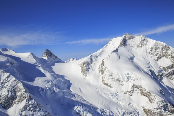 Aerial view of Piz Bernina and Cresta Guzza in winter. Engadine, Canton of  Grisons, Switzerland Europe