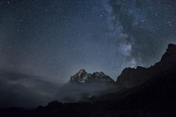 The milky way lights up the sky over Monviso. Lake Superior, Cozian Alps, Piedmont, Italy Europe