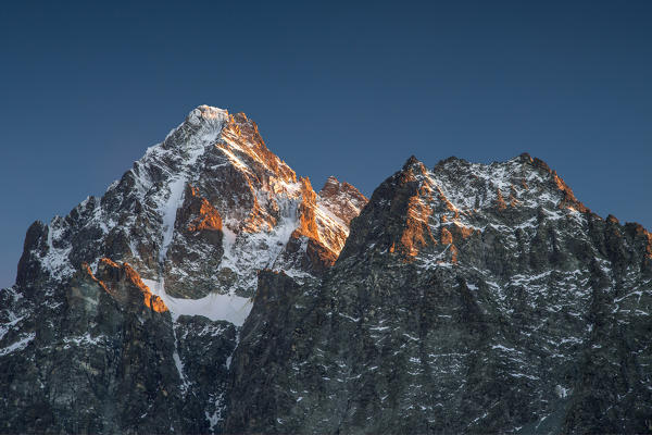 The peak of Monviso covered in snow and lighted by sunset. Monviso; Cozian Alps, Piedmont, Italy Europe