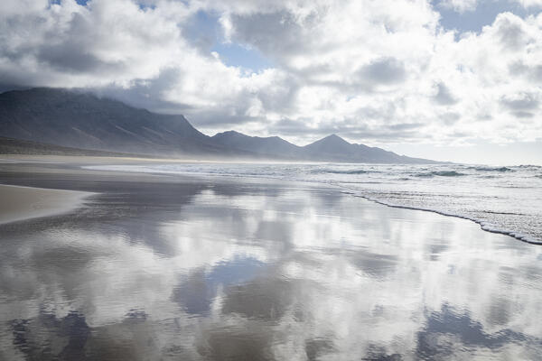 Cloudy sky at sunset reflected in the sea, Cofete Beach, Jandia nature park, Fuerteventura, Canary Islands, Spain
