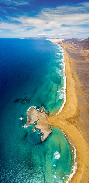 Aerial view of El Islote rock islet along the desert Cofete Beach, Jandia peninsula, Fuerteventura, Canary Islands, Spain