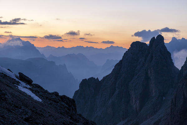 Sunset at Cadini of Misurina with the outlines of the peaks already overshadowed. Dolomites, Veneto, Italy. Europe