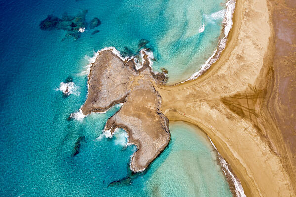 Turquoise ocean surrounding El Islote rock islet and Cofete Beach from above, Jandia, Fuerteventura, Canary Islands, Spain