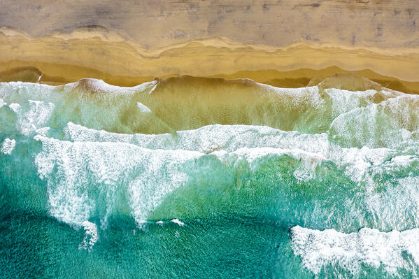 Aerial view of ocean waves crashing on the golden sand of Cofete Beach, Jandia, Fuerteventura, Canary Islands, Spain