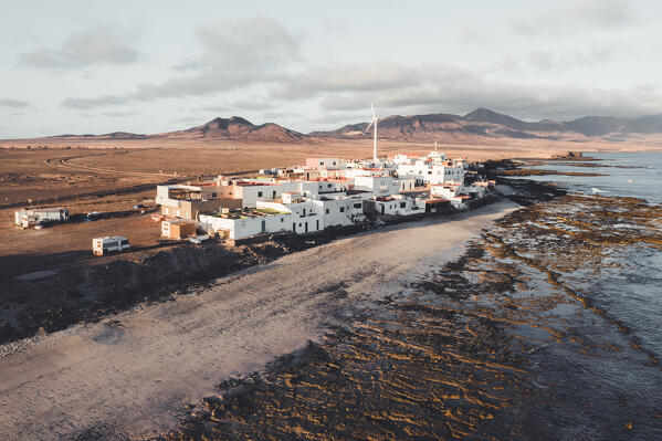 Coastal village of El Puertito and wind turbine, close to Punta de Jandia, Fuerteventura, Canary Islands, Spain