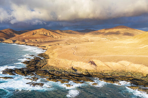 Sunset over desert rocks and Playa de la Solapa beach, aerial view, Atlantic Ocean, Fuerteventura, Canary Islands, Spain