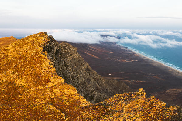 Aerial view of Pico de la Zarza peak at dawn with Cofete beach and ocean on background, Fuerteventura, Canary Islands, Spain