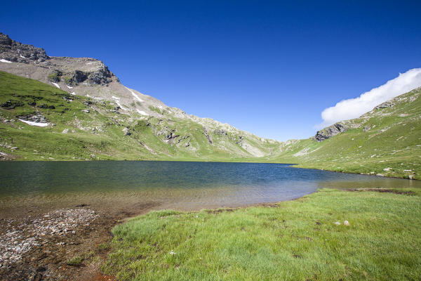 Summer contrasts at Baldiscio lake. Campodolcino, Vallespluga, Valchiavenna, Lombardy, Italy Europe