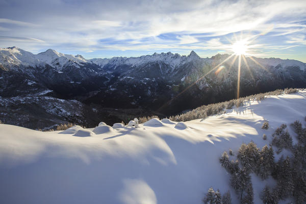 Aerial photo of Alpe Scima partially hidden by meters of snow. CHiavenna Valley. Valtellina. Lombardy. Italy. Europe