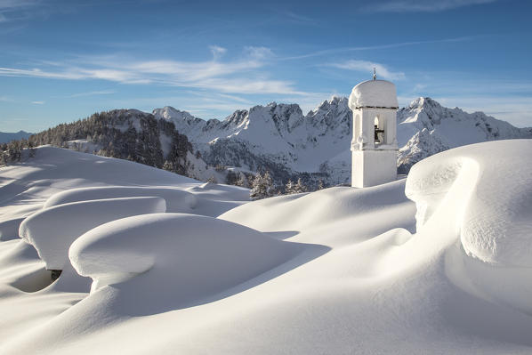 The huts and the bell tower at Alpe Scima covered in snow. Valchiavenna, Valtellina Lombardy Italy Europe