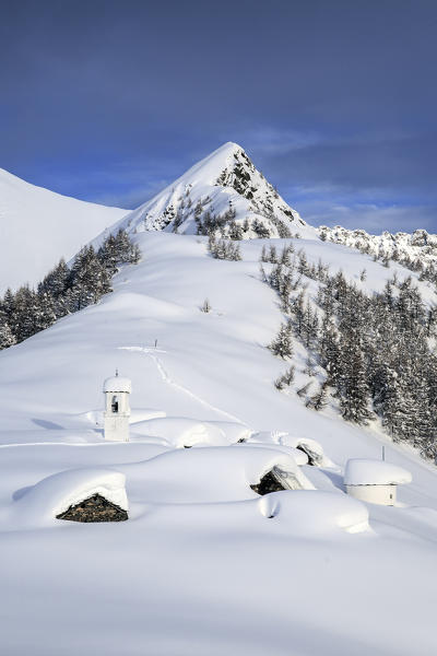 Huts in Alpe Scima covered in snow. Alpe Scima, Valchiavenna, Valtellina Lombardy, Italy Europe