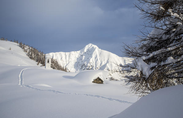 Tracks in the snow towards Alpe Scima created by hikers Valchiavenna, Valtellina Lombardy, Italy Europe