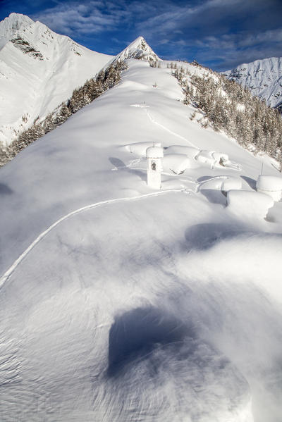 The wind moves the floury snow at Alpe Scima. Valchiavenna, Valtellina Lombardy, Italy Europe
