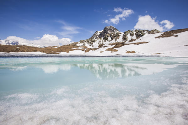 Reflections of spring on Lake Emet in thaw. Madesimo. CHiavenna Valley. Spluga Valley. Valtellina. Lombardy. Italy. Europe