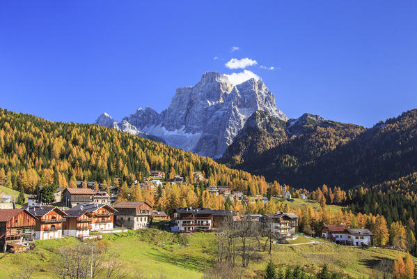 Colorful autumn larches in Selva of Cadore with Mount Pelmo in the background. Dolomites. Cadore. Veneto. Italy. Europe