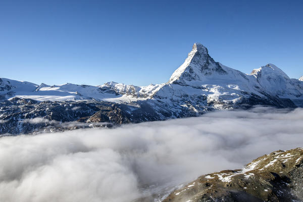 Mist in autumn hides the valley at the foot of the Matterhorn Zermatt canton of Valais Switzerland. Europe 
