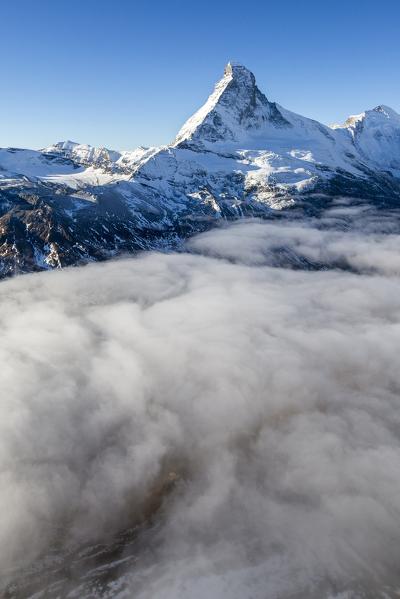 Morning fog covering the valley at the foot of the Matterhorn. Zermatt. Switzerland. Europe 