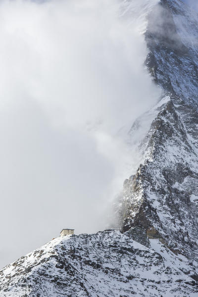 Hornli-hutte covered in the fog that hides the peak of the Matterhorn. Zermatt, Valais, Switzerland Europe