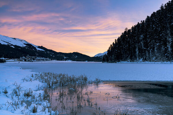 Winter sunrise over the frozen Lake Champfer covered with snow, Silvaplana, canton of Graubunden, Engadine, Switzerland