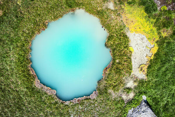 Overhead view of the tourquoise clear water of an alpine lake, Macolini, Madesimo, Valle Spluga, Valtellina, Lombardy, Italy