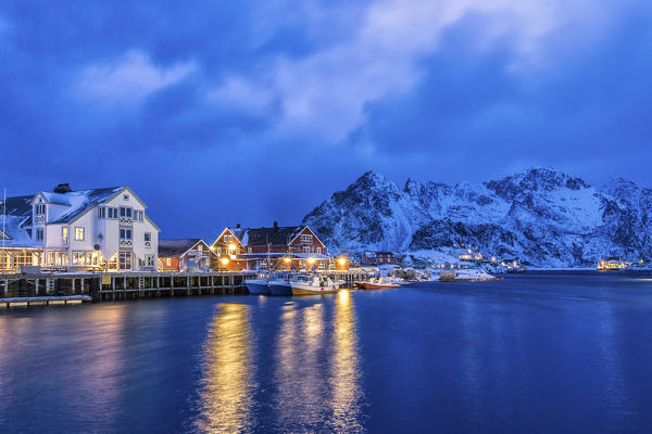 Dusk in Henningsvaer with the first lights of the evening light up. Lofoten Islands. Norway. Europe