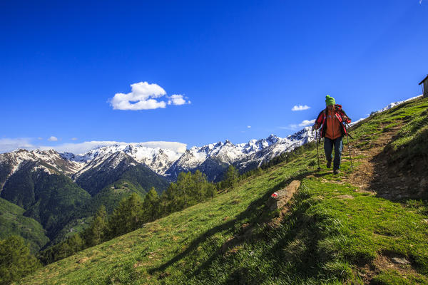 Hiker return from the top of Rosetta. Rasura. Gerola Valley Valtellina. Lombardy. Italy. Europe