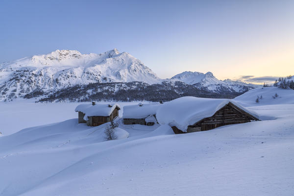 Last lights of the sunset at Spluga huts on the heights of Maloja Pass. Engadine. Switzerland. Europe