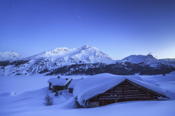 Dusk ends and night begins on Spluga huts. Maloja Pass. Engadine. Switzerland. Europe