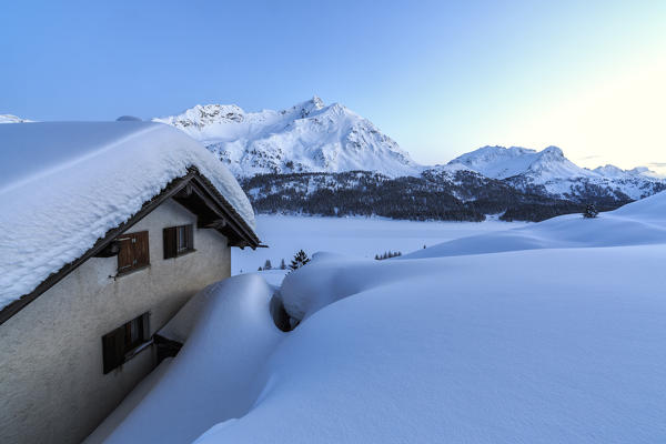 Spluga huts surrounded by snow at dusk. Maloja Pass. Engadine. Switzerland. Europe