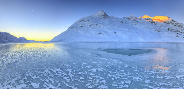 Overview of the frozen surface of Lake Bianco. Bernina Pass. Canton of Graubunden. Engadine. Switzerland. Europe 