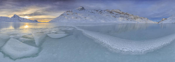 Overview of the frozen surface of Lake Bianco at Bernina Pass characterized by shapes created by the frost. Canton of Graubunden. Engadine. Switzerland. Europe